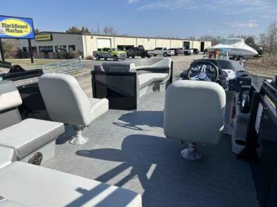 Slide: The Image of 2025 Lowe SS 230 WT pontoon boat interior with seating and steering console at Blackbeard Marine. - 11