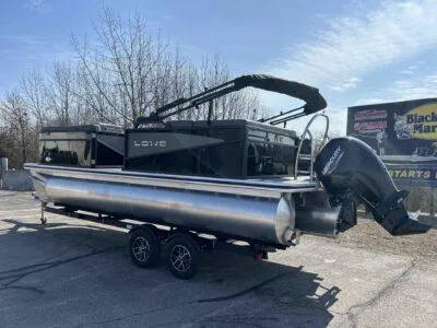 Slide: The Image of 2025 Lowe SS 230 WT pontoon boat on trailer, parked outdoors. - 6