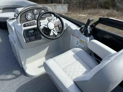 Slide: The Image of 2025 Lowe SS 230 WT boat interior with steering wheel and control panel. - 8
