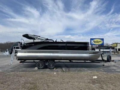 Slide: The Image of 2025 Lowe SS 230 WT pontoon boat on trailer under a cloudy sky. - 9