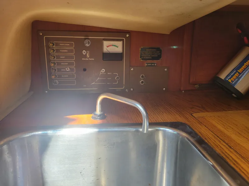Slide: The Image of Control panel and sink in a 1977 Islander 27 sailboat interior. - 13