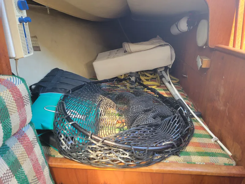 Slide: The Image of Interior of a 1977 Islander 27 sailboat with fishing gear and equipment. - 14