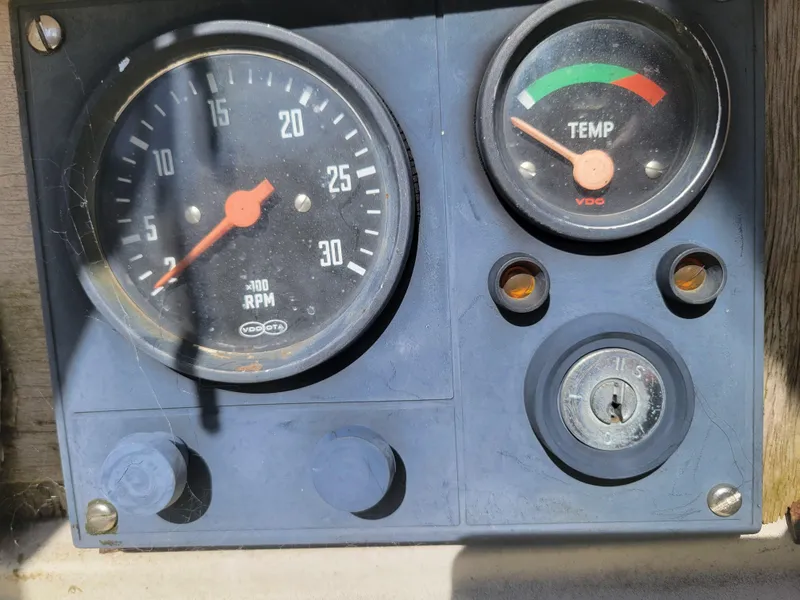 Slide: The Image of Dashboard of a 1977 Islander 27 boat with RPM and temperature gauges. - 6