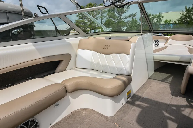 Slide: The Image of 2001 MasterCraft MariStar 230 interior with beige and white seating, showcasing luxury boat design. - 16