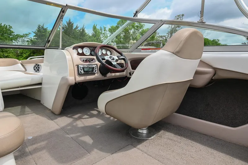 Slide: The Image of 2001 MasterCraft MariStar 230 boat interior with beige seating and modern dashboard. - 17