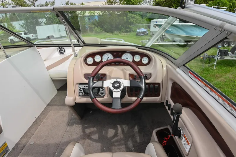 Slide: The Image of 2001 MasterCraft MariStar 230 boat cockpit with steering wheel and dashboard controls. - 18