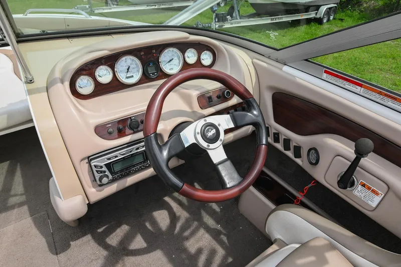 Slide: The Image of 2001 MasterCraft MariStar 230 dashboard with steering wheel and control panel. - 19