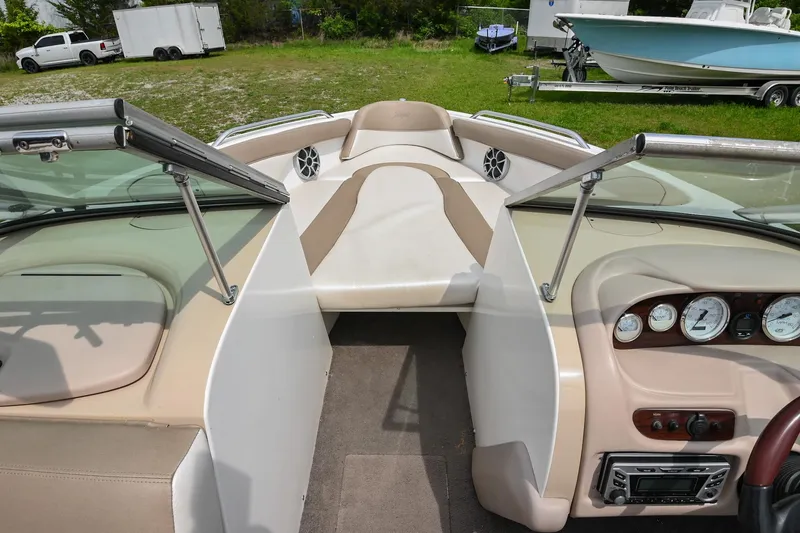 Slide: The Image of 2001 MasterCraft MariStar 230 boat interior with beige seating and dashboard controls. - 21