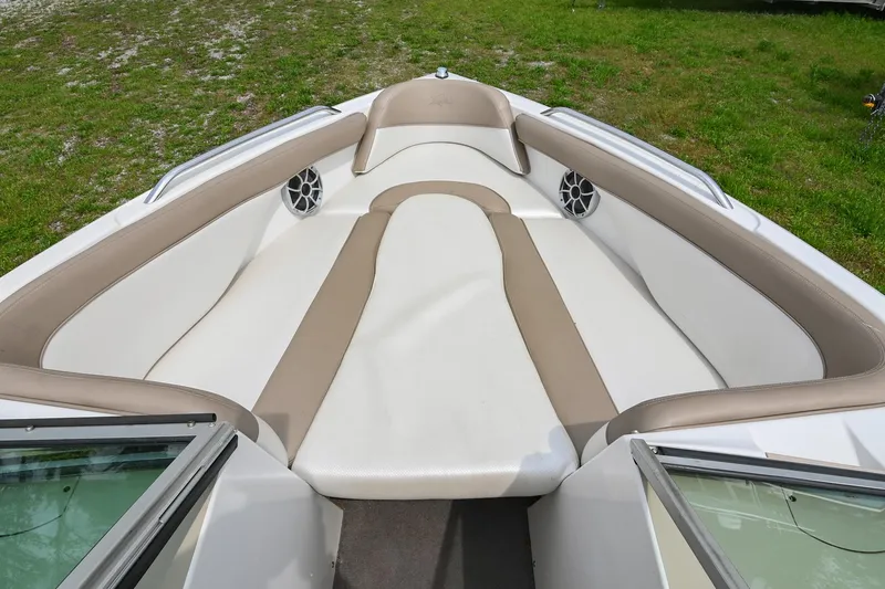 Slide: The Image of 2001 MasterCraft MariStar 230 boat interior with beige and white seating, outdoor setting. - 22
