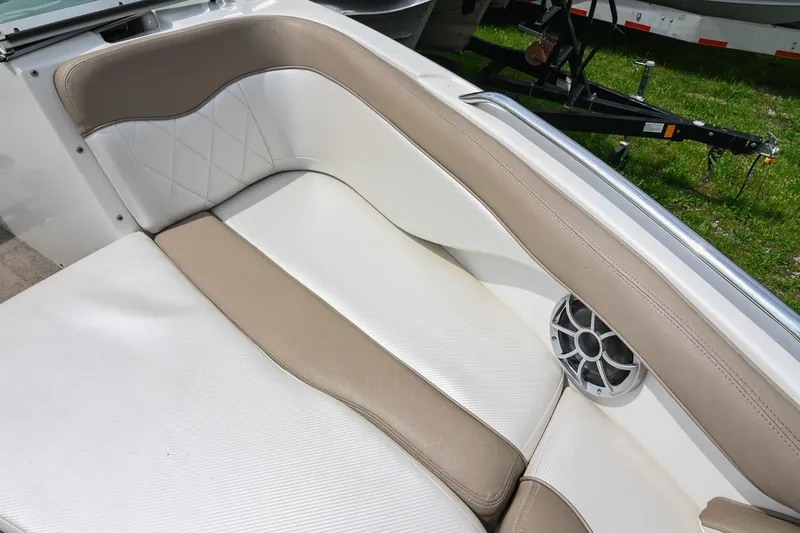 Slide: The Image of 2001 MasterCraft MariStar 230 boat interior with beige and white seating, featuring a speaker. - 23
