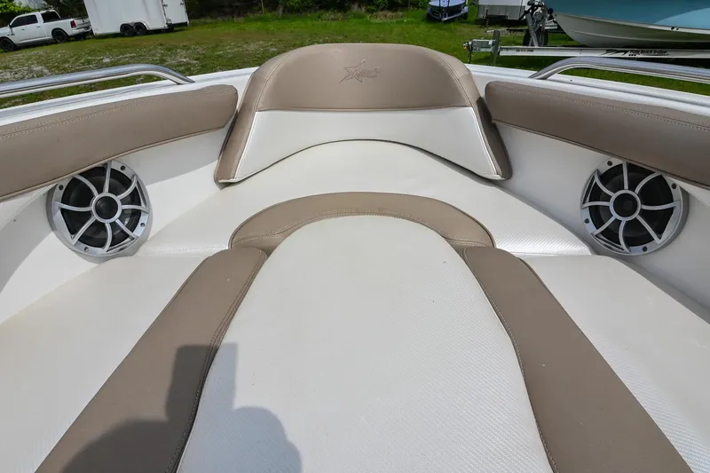Slide: The Image of 2001 MasterCraft MariStar 230 boat interior with beige and white seating, featuring built-in speakers. - 24