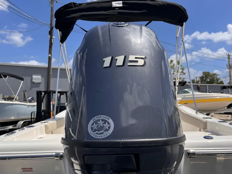 Slide: The Image of 2025 Key West 179 FS boat with 115 horsepower engine, outdoor marina setting. - 16