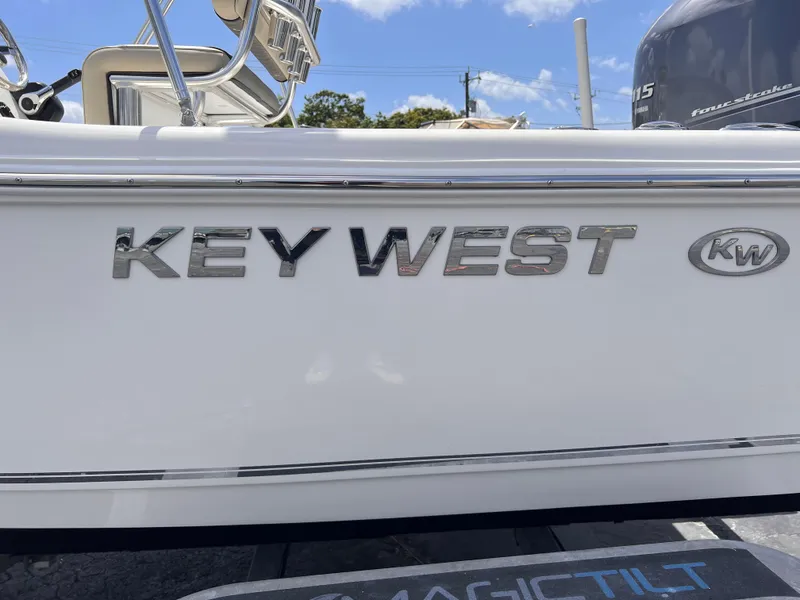 Slide: The Image of 2025 Key West 179 FS boat with logo, white exterior, and blue sky background. - 4