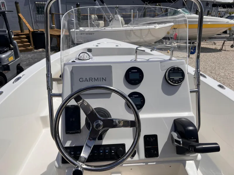 Slide: The Image of 2025 Key West 179 FS boat dashboard with Garmin navigation system and steering wheel. - 6