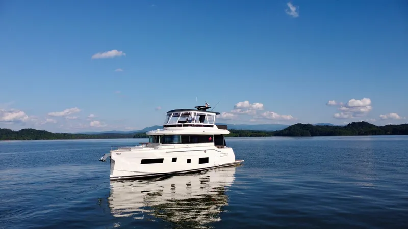 Slide: The Image of Sirena 58 yacht from 2021 on calm water under a clear blue sky. - 12