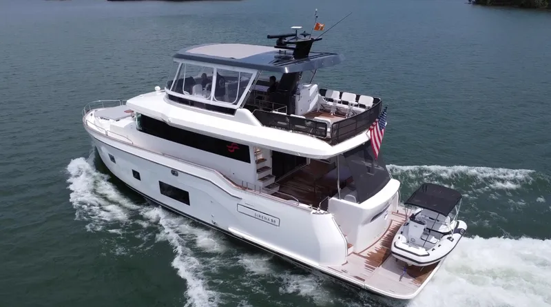 Slide: The Image of Luxury 2021 Sirena 58 yacht cruising on open water, featuring sleek design and spacious deck. - 14