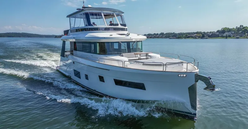 Slide: The Image of 2021 Sirena 58 yacht cruising on a calm lake under clear skies. - 22