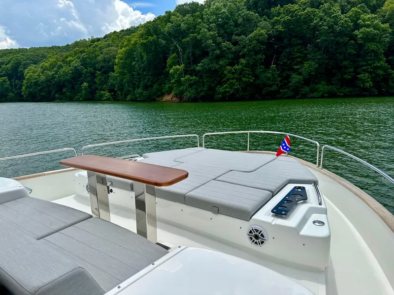 Slide: The Image of Luxurious 2021 Sirena 58 yacht deck with sunbeds, cruising on a serene lake. - 27