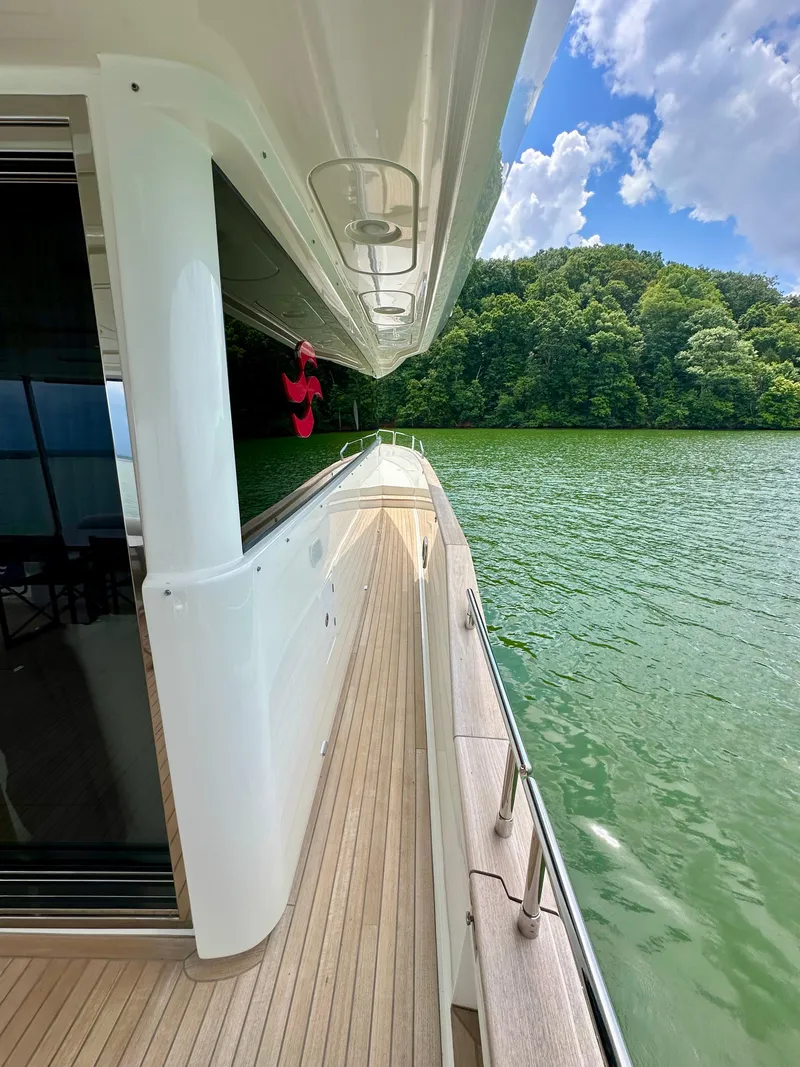 Slide: The Image of Sirena 58 yacht, 2021 model, cruising on a serene lake with lush greenery. - 39