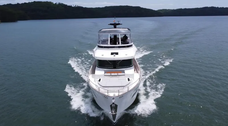 Slide: The Image of Sirena 58 yacht cruising on a serene lake, 2021 model, front view. - 4