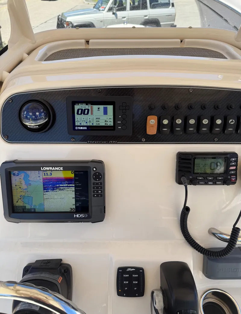 Slide: The Image of 2017 Grady-White Fisherman 209 dashboard with navigation and communication equipment. - 10