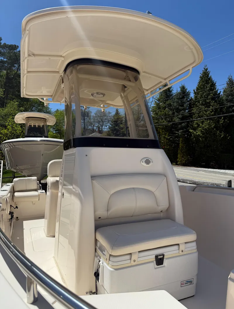 Slide: The Image of 2017 Grady-White Fisherman 209 boat with T-top, viewed from the side, under clear blue sky. - 6