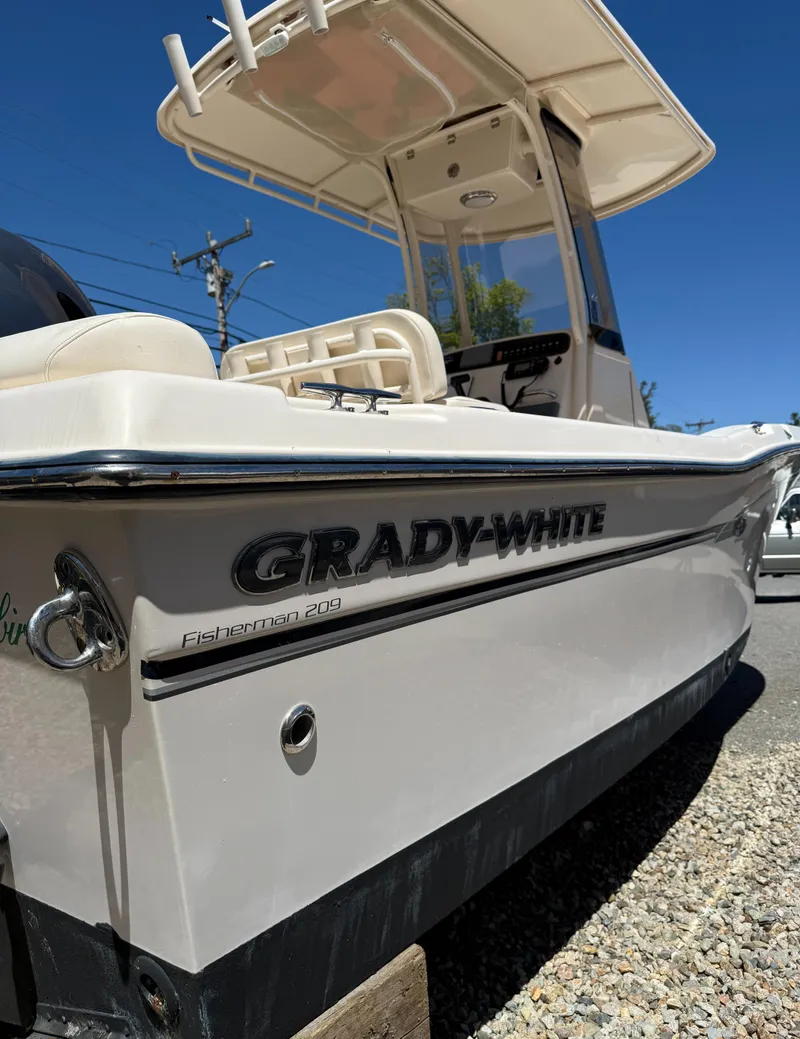 Slide: The Image of 2017 Grady-White Fisherman 209 boat, side view, showcasing sleek design and branding. - 7