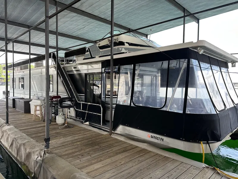 Slide: The Image of 1992 Sumerset 14x70 houseboat docked under a covered marina. - 0