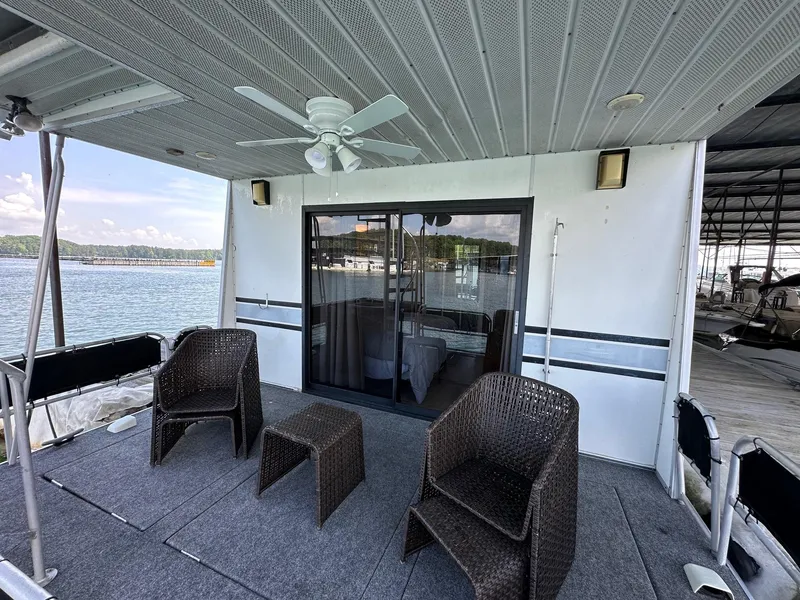 Slide: The Image of Outdoor deck of 1992 Sumerset 14x70 houseboat with wicker chairs and lake view. - 13