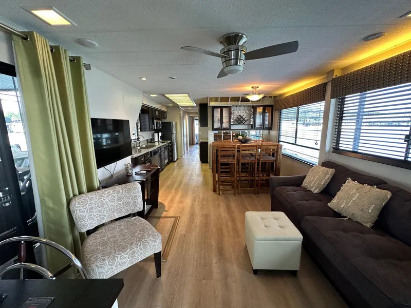 Slide: The Image of Luxurious 1992 Sumerset 14x70 houseboat interior with modern living area and kitchen. - 2