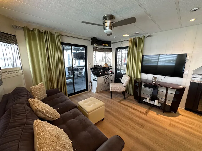 Slide: The Image of Living area in 1992 Sumerset 14x70 houseboat with modern decor and entertainment setup. - 3
