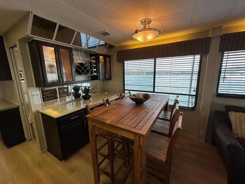 Slide: The Image of Interior of a 1992 Sumerset 14x70 houseboat with dining area and lake view. - 5