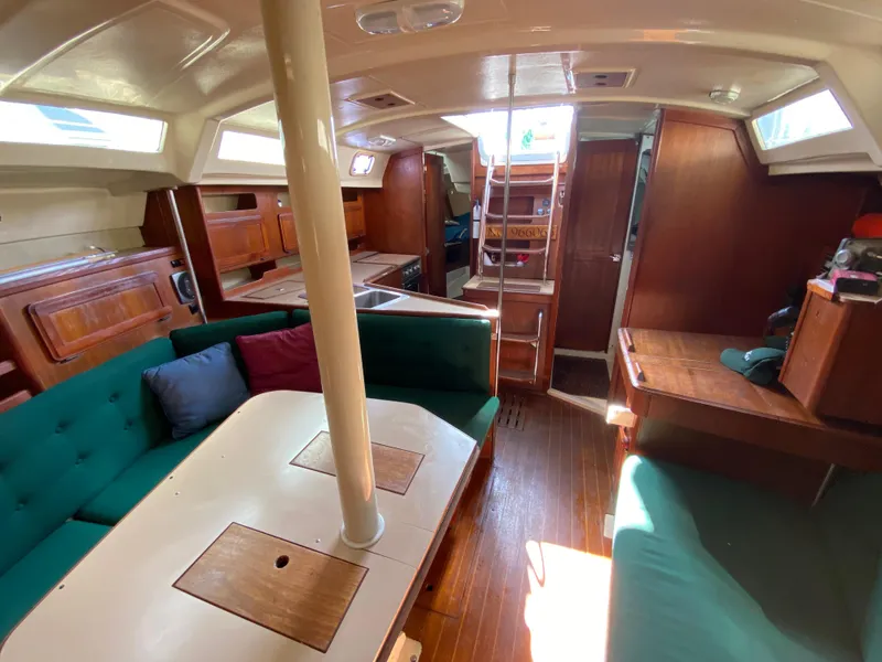 Slide: The Image of Interior of 1989 Hunter Legend 40 sailboat with wood finishes and green seating. - 10