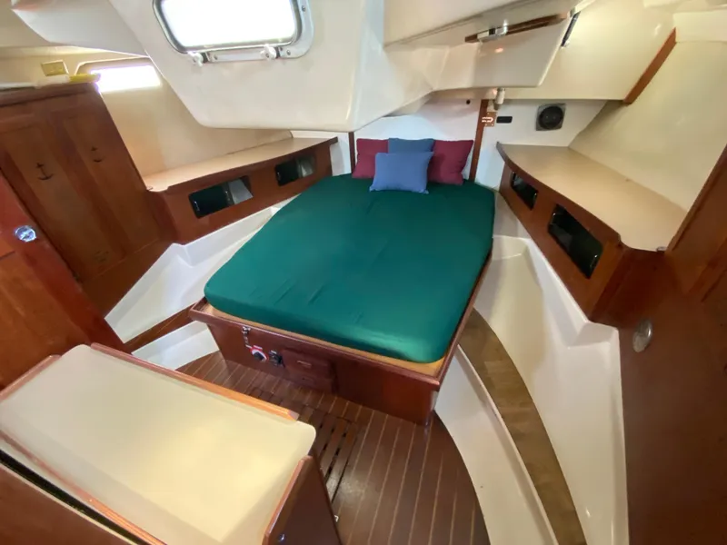 Slide: The Image of 1989 Hunter Legend 40 yacht interior with cozy cabin and green bedding. - 16