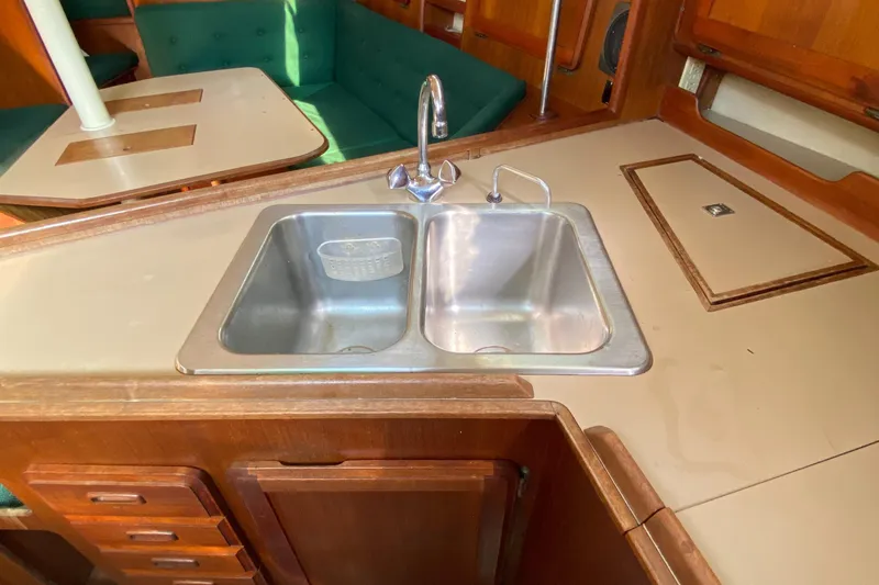 Slide: The Image of 1989 Hunter Legend 40 yacht kitchen with double sink and wooden cabinetry. - 29
