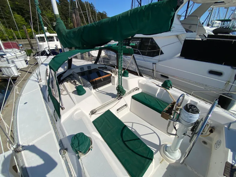 Slide: The Image of 1989 Hunter Legend 40 sailboat with green accents docked at a marina. - 3