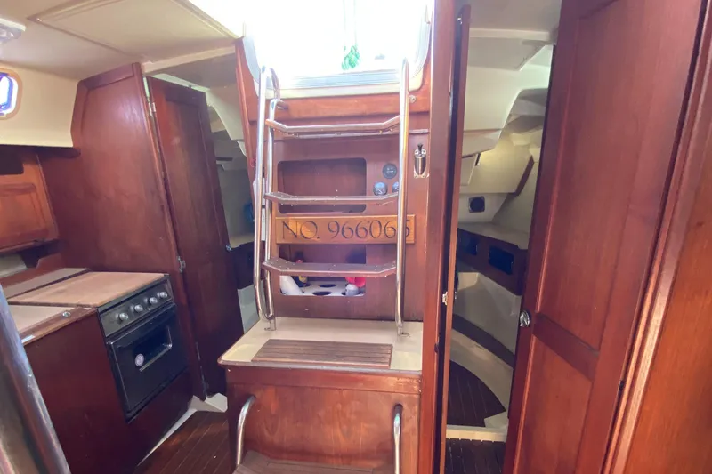 Slide: The Image of Interior of 1989 Hunter Legend 40 sailboat with wooden cabinetry and compact kitchen area. - 30