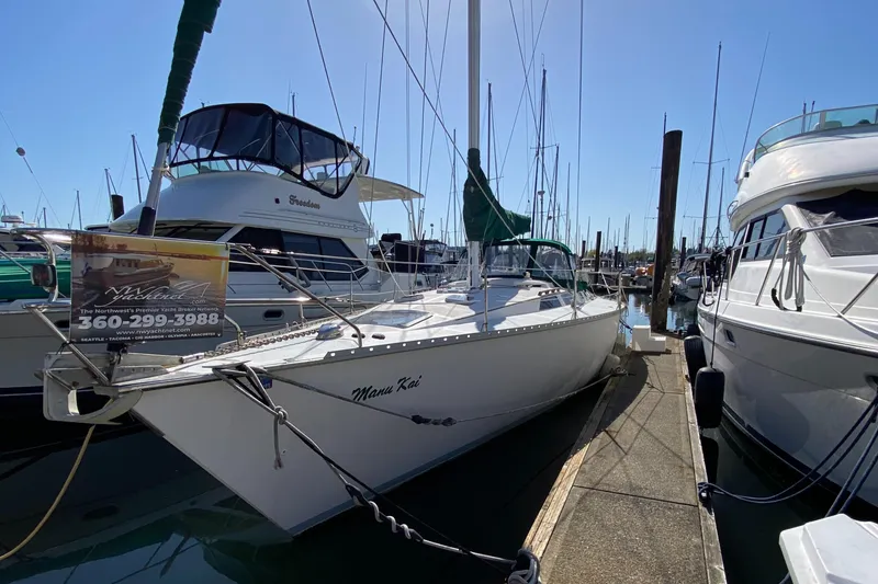 Slide: The Image of 1989 Hunter Legend 40 sailboat docked at marina, surrounded by other boats. - 33