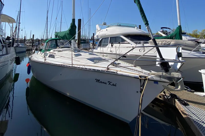 Slide: The Image of 1989 Hunter Legend 40 sailboat docked at marina, surrounded by other boats. - 34