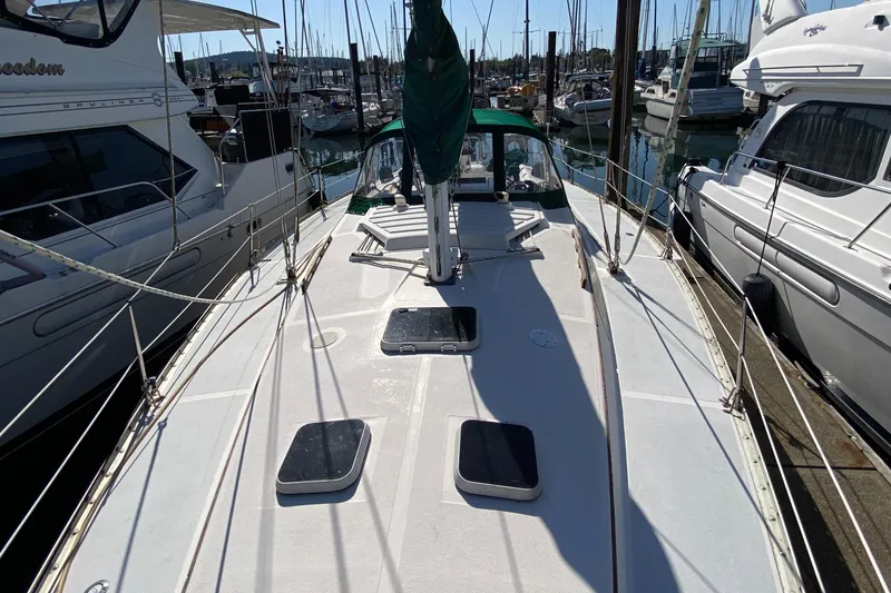 Slide: The Image of 1989 Hunter Legend 40 sailboat deck view in marina, surrounded by other boats. - 37