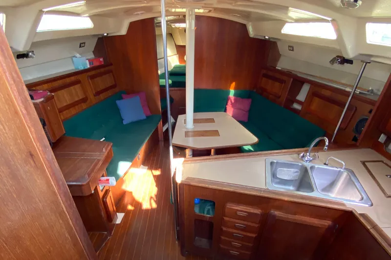 Slide: The Image of Interior of 1989 Hunter Legend 40 sailboat with wood finish and cozy seating area. - 4