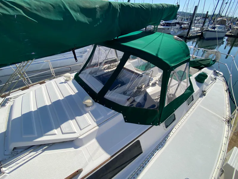 Slide: The Image of 1989 Hunter Legend 40 sailboat with green canopy docked at marina. - 40