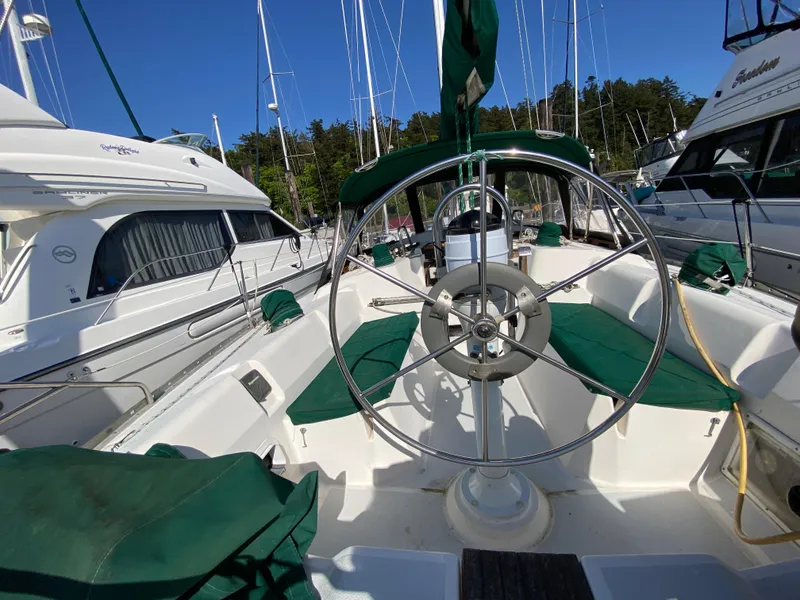 Slide: The Image of 1989 Hunter Legend 40 sailboat cockpit with green seating and steering wheel. - 42