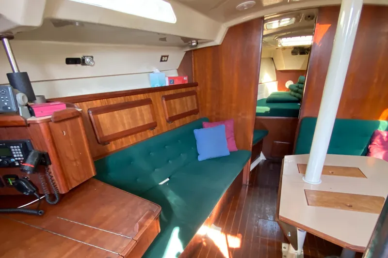 Slide: The Image of Interior of 1989 Hunter Legend 40 sailboat with wooden furnishings and green seating. - 5