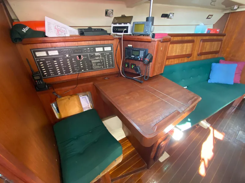 Slide: The Image of 1989 Hunter Legend 40 yacht interior with navigation station and seating area. - 9
