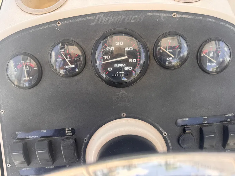 Slide: The Image of Dashboard of a 1999 Shamrock 246 Open boat with gauges and controls. - 5