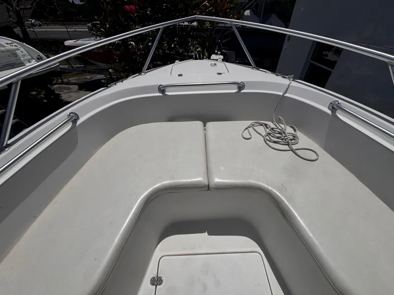 Slide: The Image of 1999 Shamrock 246 Open boat bow with seating and railing, featuring a coiled rope. - 6