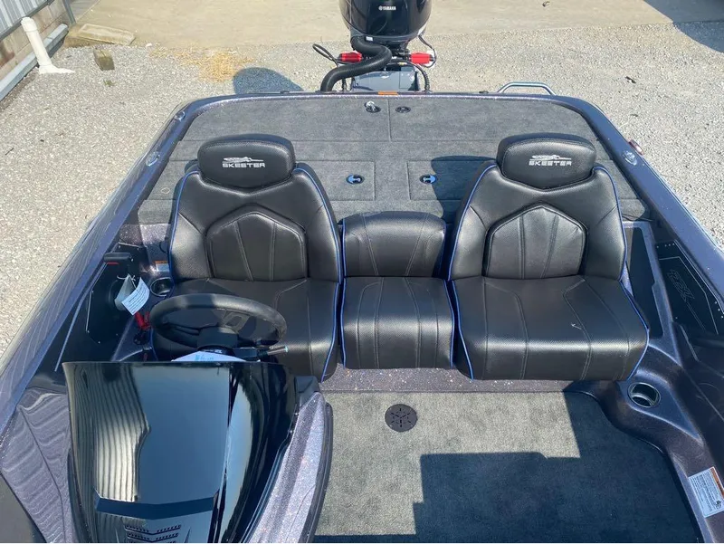 Slide: The Image of 2025 Skeeter ZX150 boat interior with black leather seats and steering wheel. - 17