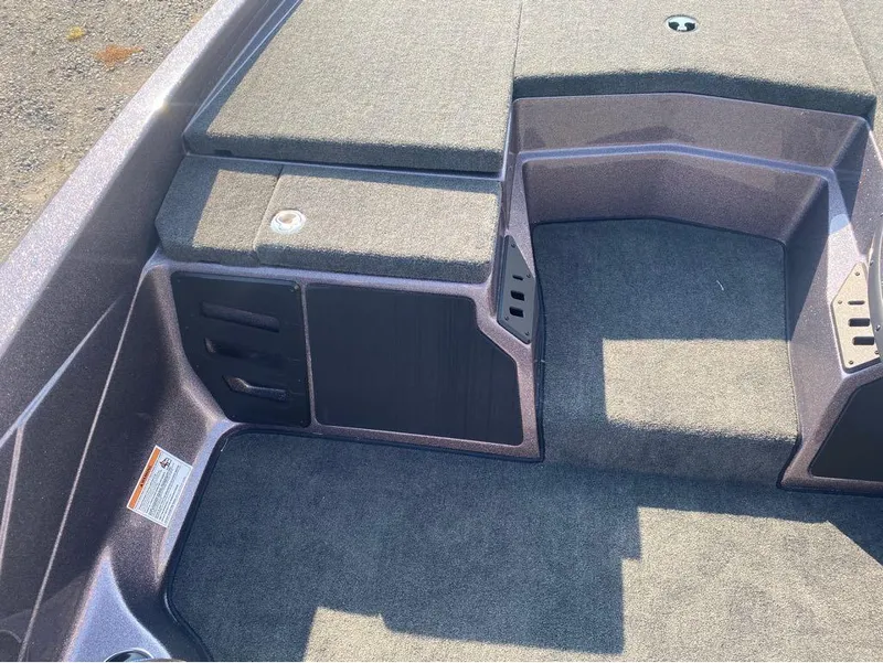 Slide: The Image of 2025 Skeeter ZX150 boat interior with carpeted deck and storage compartments. - 3