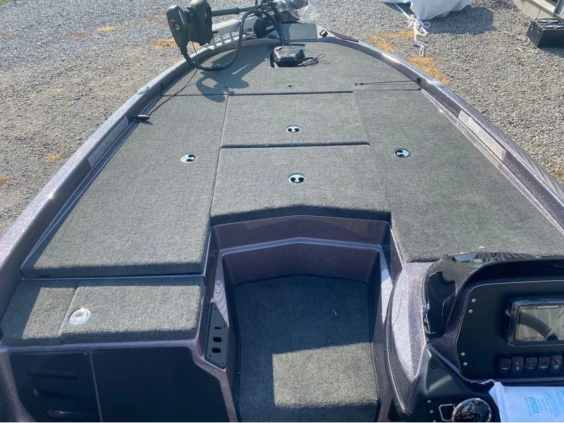 Slide: The Image of 2025 Skeeter ZX150 boat deck with carpeted storage compartments and control panel. - 7